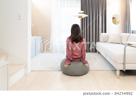 Woman relaxing in the living room 84254992