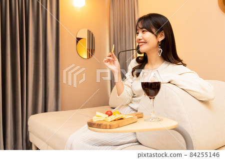 Females having a good time with wine and snacks Home time Females having a good time with wine and snacks Home time 84255146