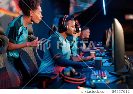 Skillful team practicing in gaming arena at internet club Skillful team practicing in gaming arena at internet club 84257612