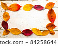 Autumn, fall foliage and shabby chic vintage antique white table 84258644
