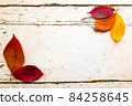 Autumn, fall foliage and shabby chic vintage antique white table 84258645