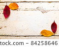 Autumn, fall foliage and shabby chic vintage antique white table 84258646