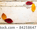Autumn, fall foliage and shabby chic vintage antique white table 84258647