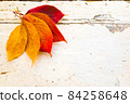 Autumn, fall foliage and shabby chic vintage antique white table 84258648