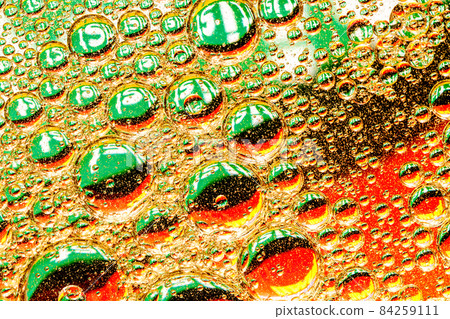 Oil drops on green background Oil drops on green background 84259111