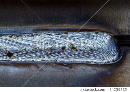 welding seam onto steel sheet metal, Closeup 84259385