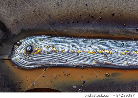 welding seam onto steel sheet metal, Closeup welding seam onto steel sheet metal, Closeup 84259387