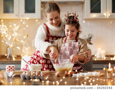 happy family mother and child bake christmas cookies 84260348