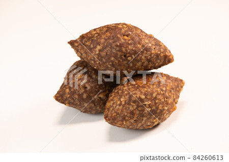 Traditional kebbe and pita bread on big round plate in lebanese restaurant Traditional kebbe and pita bread on big round plate in lebanese restaurant 84260613