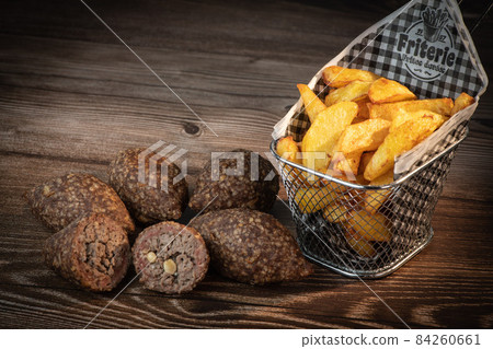 Traditional kebbe and pita bread on big round plate in lebanese restaurant 84260661