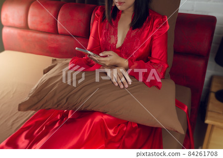 Women looking live streaming on a smartphone at night. 84261708