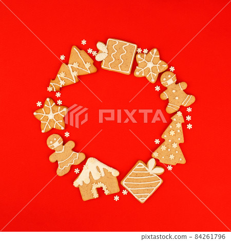 Happy New Year 2022 Wreath. Christmas, winter holidays concept. Set of Gingerbread cookie, stars, man in medical mask on traditional red background, Trendy fleyer, invitation, greetincard, banner 84261796