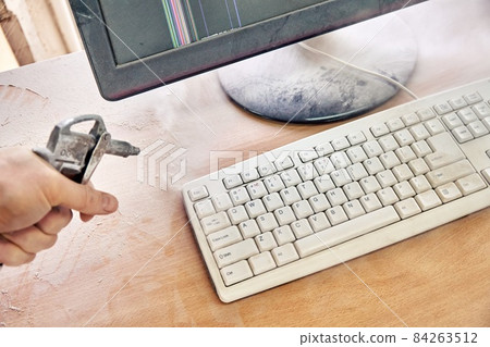 Cleaning a dusty keyboard with a compressed air gun 84263512