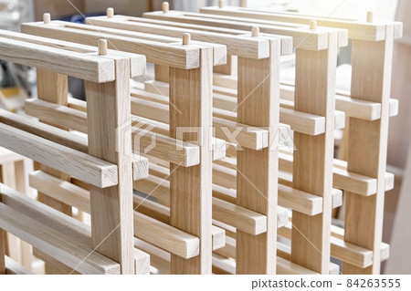 Wine rack of solid oak in the workshop closeup 84263555