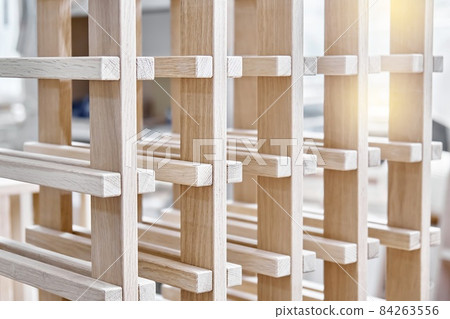 Wine rack of solid oak in the workshop closeup Wine rack of solid oak in the workshop closeup 84263556