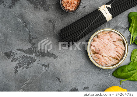 Pasta with tuna raw ingredients, on gray stone table background, top view flat lay, with copy space for text 84264782
