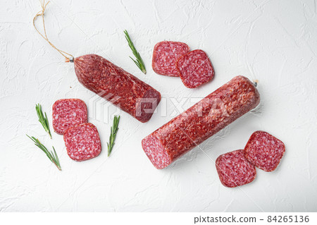 Salami, salami smoked sausage, sliced, on white stone table background, top view flat lay 84265136