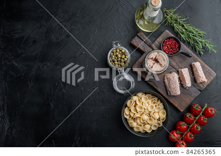 Tuna pasta ingredients, on black background, top view with copy space for text 84265365