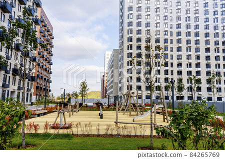 Beautiful multi colorful building of new modern residential area for young families. Playground in public yard. Residential district with bright facade geometry Beautiful multi colorful building of new modern residential area for young families. Playground in public yard. Residential district with bright facade geometry 84265769