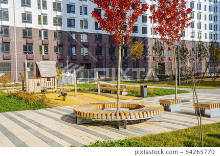 Beautiful multi colorful building of new modern residential area for young families. Playground in public yard. Residential district with bright facade geometry 84265770