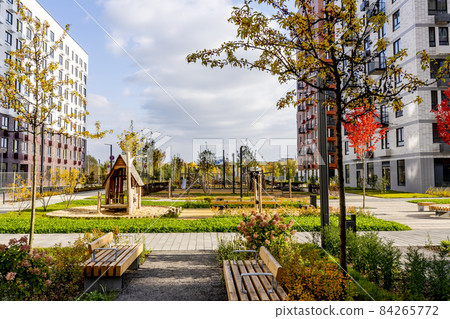 Beautiful multi colorful building of new modern residential area for young families. Playground in public yard. Residential district with bright facade geometry Beautiful multi colorful building of new modern residential area for young families. Playground in public yard. Residential district with bright facade geometry 84265772