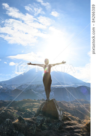 Hiker young woman enjoys nature on top of a mountain 84266389