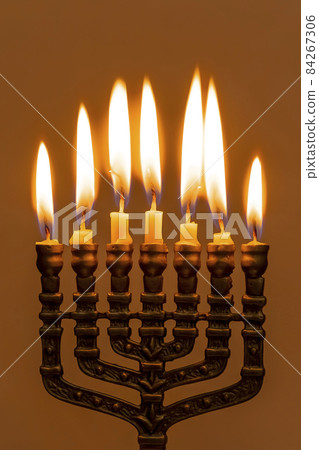 Hanukkah menorah closeup with burning candles for holiday card background. Retro old style hanukkah Hanukkah menorah closeup with burning candles for holiday card background. Retro old style hanukkah 84267306