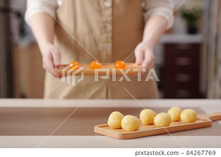 Woman Preparing Mooncakes at Home Woman Preparing Mooncakes at Home 84267769