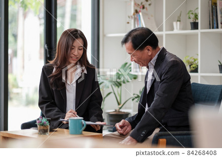 Friendly lawyer or financial advisor in suit consulting elder man, smiling investment broker or bank worker making loan offer, giving legal advice, selling insurance or real estate to customers 84268408