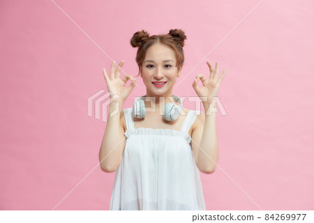 Young asian woman showing a OK hand sign. 84269977