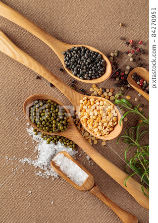 Various raw lentils with rosemary, salt and pepper. Various raw lentils with rosemary, salt and pepper. 84270951