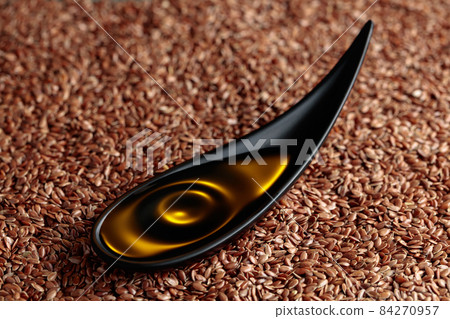 Fflaxseed oil in small black bowl. Fflaxseed oil in small black bowl. 84270957