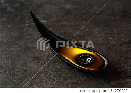 Vegetable oil in small bowl on a stone table. Vegetable oil in small bowl on a stone table. 84270961