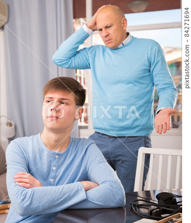 Man scolding son at home Man scolding son at home 84271694
