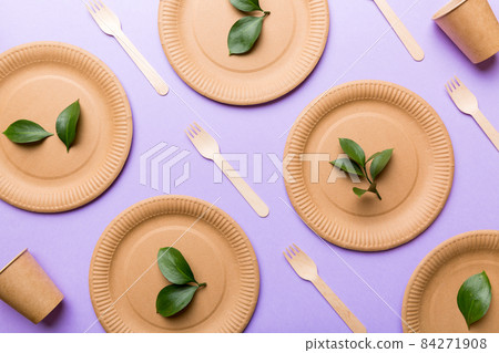 set of empty reusable disposable eco-friendly plates, cups, utensils on light white colored table background. top view. Biodegradable craft dishes. Recycling concept. Close-up 84271908
