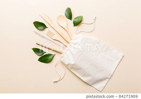 Eco friendly reusable recyclable white eco bag with kitchenware on Colored background. Concept zero waste 84271909