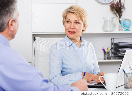Business partners discussing documents Business partners discussing documents 84272062