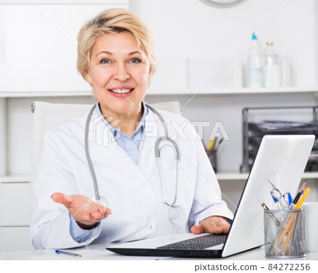 Doctor in gown waiting for patient Doctor in gown waiting for patient 84272256