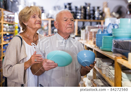 Mature couple choosing new dishware at store Mature couple choosing new dishware at store 84272560