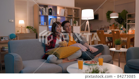 couple watch tv at home 84273085