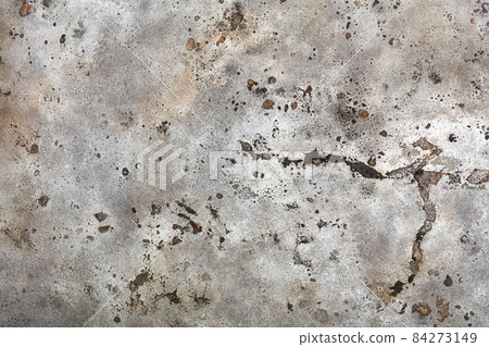 Texture of old weathered beige paint on a metal sheet with rusty spots, cracks and bumps. 84273149