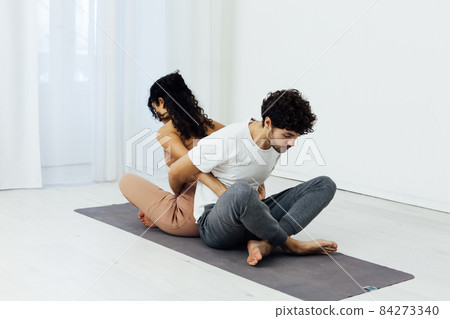 a man and a woman engaged in paired gymnastics yoga asana 84273340