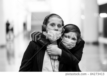 Children with face mask going back to school after covid-19 quarantine and lockdown. 84273413