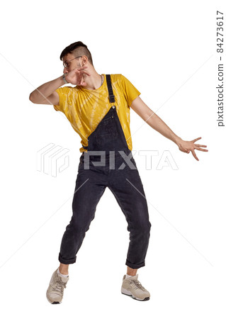 Full-length portrait of a funny guy dancing in studio isolated on white background. Full-length portrait of a funny guy dancing in studio isolated on white background. 84273617