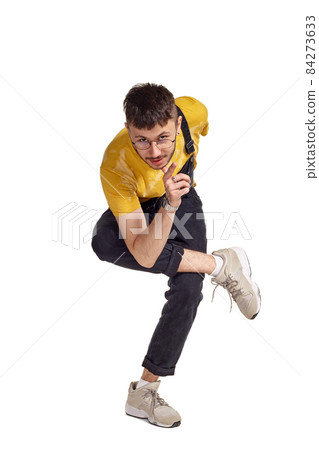 Full-length portrait of a funny guy dancing in studio isolated on white background. Full-length portrait of a funny guy dancing in studio isolated on white background. 84273633