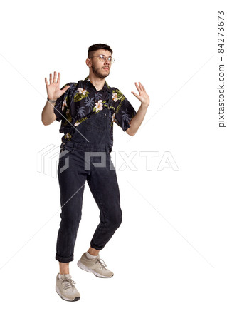 Full-length portrait of a funny guy dancing in studio isolated on white background. Full-length portrait of a funny guy dancing in studio isolated on white background. 84273673