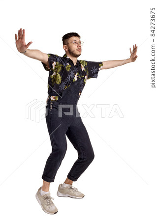 Full-length portrait of a funny guy dancing in studio isolated on white background. Full-length portrait of a funny guy dancing in studio isolated on white background. 84273675