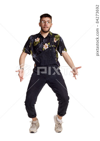 Full-length portrait of a funny guy dancing in studio isolated on white background. Full-length portrait of a funny guy dancing in studio isolated on white background. 84273692