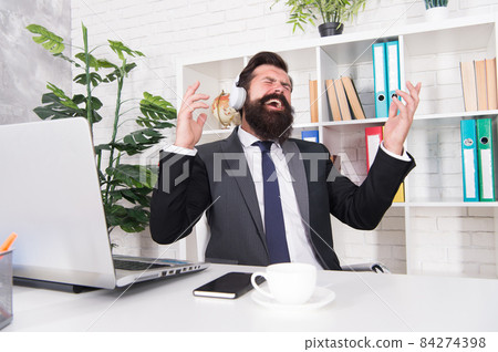 Music for stress relief. Businessman enjoy music in office. Music for stress relief. Businessman enjoy music in office. 84274398