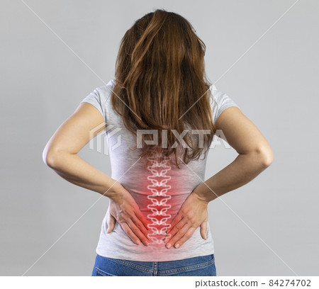 Young woman suffering from lower back pain Young woman suffering from lower back pain 84274702